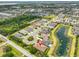 Beautiful aerial view of a well-planned community, showcasing the home's proximity to a serene pond at 15303 Valencia Del Sol St, Wimauma, FL 33598