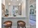 Stylish bar area featuring granite countertops, custom cabinets and pendant lighting at 15303 Valencia Del Sol St, Wimauma, FL 33598