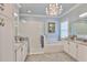 Bright bathroom features a walk-in shower, soaking tub, and white cabinetry at 15303 Valencia Del Sol St, Wimauma, FL 33598