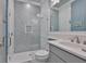 Nicely remodeled bathroom featuring a beautiful tile shower, glass door, and white vanity at 15303 Valencia Del Sol St, Wimauma, FL 33598