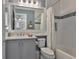 Clean and bright bathroom with a shower and tub, large mirror, and white fixtures at 15303 Valencia Del Sol St, Wimauma, FL 33598