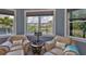 Bright bedroom sitting area with leather chairs and views of the backyard at 15303 Valencia Del Sol St, Wimauma, FL 33598