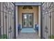 Elegant front entrance featuring a decorative security gate, double glass doors, and a tiled entryway at 15303 Valencia Del Sol St, Wimauma, FL 33598