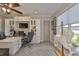 This spacious home office features a large desk, built-in shelving, and a ceiling fan at 15303 Valencia Del Sol St, Wimauma, FL 33598