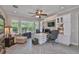 Bright home office includes custom built-ins, a large window, and a ceiling fan at 15303 Valencia Del Sol St, Wimauma, FL 33598