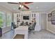 This home office space includes a large desk, built-in shelving, and an expansive window at 15303 Valencia Del Sol St, Wimauma, FL 33598
