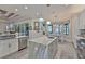 Open concept kitchen with a large island, tile floor, and view to backyard at 15303 Valencia Del Sol St, Wimauma, FL 33598