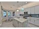 Well-lit kitchen with stainless steel appliances, island, and breakfast nook at 15303 Valencia Del Sol St, Wimauma, FL 33598