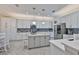 Spacious kitchen featuring stainless steel appliances, custom cabinets, and a center island at 15303 Valencia Del Sol St, Wimauma, FL 33598