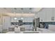 Spacious kitchen with stainless steel appliances, blue backsplash and pendant lighting at 15303 Valencia Del Sol St, Wimauma, FL 33598