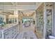 Elegant living room featuring tile floors, tray ceilings, decorative display cabinet, and an open floor plan at 15303 Valencia Del Sol St, Wimauma, FL 33598