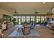 Relaxing sunroom filled with comfortable seating, lush plants, and natural light at 15303 Valencia Del Sol St, Wimauma, FL 33598