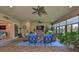 Spacious sunroom with comfortable seating, a ceiling fan, and a view of the backyard at 15303 Valencia Del Sol St, Wimauma, FL 33598