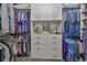 Well-organized walk-in closet features custom built-in shelves and cabinets at 15303 Valencia Del Sol St, Wimauma, FL 33598
