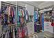This spacious walk-in closet is equipped with custom shelving and ample hanging space at 15303 Valencia Del Sol St, Wimauma, FL 33598