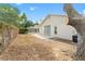 A partially fenced backyard with a screened in porch and patio at 1654 Portsmouth Lake Dr, Brandon, FL 33511