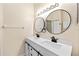 Updated bathroom featuring double vanity, modern black fixtures, and stylish mirrors at 1654 Portsmouth Lake Dr, Brandon, FL 33511