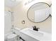 Updated bathroom featuring a tub with shower, toilet, and a modern vanity with black fixtures at 1654 Portsmouth Lake Dr, Brandon, FL 33511