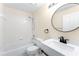 Bathroom featuring a tub with shower, toilet, and a single vanity with black fixtures at 1654 Portsmouth Lake Dr, Brandon, FL 33511