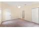 Large bedroom featuring carpet flooring, ceiling fan, and large windows at 1654 Portsmouth Lake Dr, Brandon, FL 33511