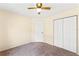Cozy bedroom featuring carpet flooring, white trim, ceiling fan, and ample closet space at 1654 Portsmouth Lake Dr, Brandon, FL 33511