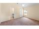 Cozy bedroom with carpeted floors, neutral walls, ceiling fan, and ensuite bathroom at 1654 Portsmouth Lake Dr, Brandon, FL 33511
