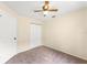 This bedroom features neutral walls and carpet with a ceiling fan and closet at 1654 Portsmouth Lake Dr, Brandon, FL 33511