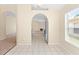 Breakfast nook with arched doorways, tile floor, baseboard trim, and neutral walls leading to the kitchen at 1654 Portsmouth Lake Dr, Brandon, FL 33511