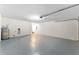 Spacious garage with water heater, washer/dryer connections, and finished floor at 1654 Portsmouth Lake Dr, Brandon, FL 33511