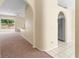 Hallway with arched doorways, carpeting, baseboard trim, and neutral walls leading to living areas at 1654 Portsmouth Lake Dr, Brandon, FL 33511