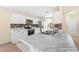 Renovated kitchen features marble countertops, stainless appliances, and stone backsplash at 1654 Portsmouth Lake Dr, Brandon, FL 33511