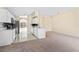 Bright kitchen featuring white cabinets, mosaic backsplash, stainless steel appliances, and an open floor plan at 1654 Portsmouth Lake Dr, Brandon, FL 33511