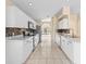 Bright kitchen with white cabinets, marble counters, stainless appliances, and open view to the breakfast nook at 1654 Portsmouth Lake Dr, Brandon, FL 33511