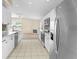 Bright kitchen features stainless steel appliances and marble countertops overlooking the living area at 1654 Portsmouth Lake Dr, Brandon, FL 33511