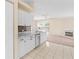 Well-lit kitchen features white cabinets, stone backsplash, and marble countertops at 1654 Portsmouth Lake Dr, Brandon, FL 33511