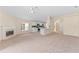Open-concept living area with fireplace, carpet flooring, and arched entryways at 1654 Portsmouth Lake Dr, Brandon, FL 33511