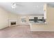 Spacious living room with a fireplace and an open-concept kitchen and ceiling fan at 1654 Portsmouth Lake Dr, Brandon, FL 33511