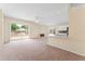 Bright living room featuring sliding glass doors, ceiling fan, and open kitchen with marble countertops at 1654 Portsmouth Lake Dr, Brandon, FL 33511