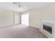 Cozy living room with a fireplace, neutral paint, and sliding glass door at 1654 Portsmouth Lake Dr, Brandon, FL 33511