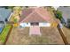 Aerial view of the backyard with screen patio, brick patio, and fenced perimeter at 19910 Wyndmill Cir, Odessa, FL 33556