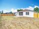 Back exterior view of the home showing the screened patio and perimeter fence at 19910 Wyndmill Cir, Odessa, FL 33556