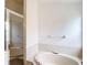 Bathroom features shower with glass door, soaking tub, and tile surround at 19910 Wyndmill Cir, Odessa, FL 33556