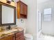 Bathroom showcases granite countertops, a wooden vanity, and a walk-in shower at 19910 Wyndmill Cir, Odessa, FL 33556