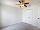 Bedroom features carpeted floors, a ceiling fan, and closet at 19910 Wyndmill Cir, Odessa, FL 33556