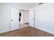 Bright bedroom with new flooring and view of kitchen area through double doors at 19910 Wyndmill Cir, Odessa, FL 33556