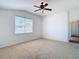 A comfortable bedroom featuring a ceiling fan, a window with blinds, and carpeted floors at 19910 Wyndmill Cir, Odessa, FL 33556