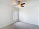 Cozy bedroom features carpeted floors, a ceiling fan, and a window with blinds at 19910 Wyndmill Cir, Odessa, FL 33556