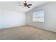 Bright bedroom showcasing a vaulted ceiling, large window, and neutral carpet flooring at 19910 Wyndmill Cir, Odessa, FL 33556