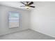 Bedroom features a ceiling fan and a window with natural light at 19910 Wyndmill Cir, Odessa, FL 33556