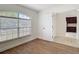 Bright bedroom with new flooring and view of kitchen area through partially opened door at 19910 Wyndmill Cir, Odessa, FL 33556
